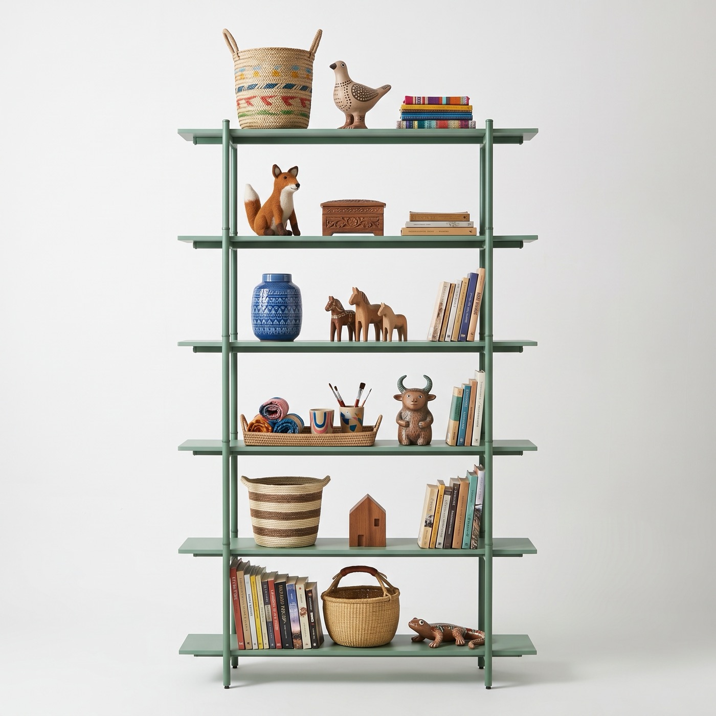 A tall shelf in sage green steel with six shelves, holding baskets, a row of books, a blue vase and carved wooden animals.