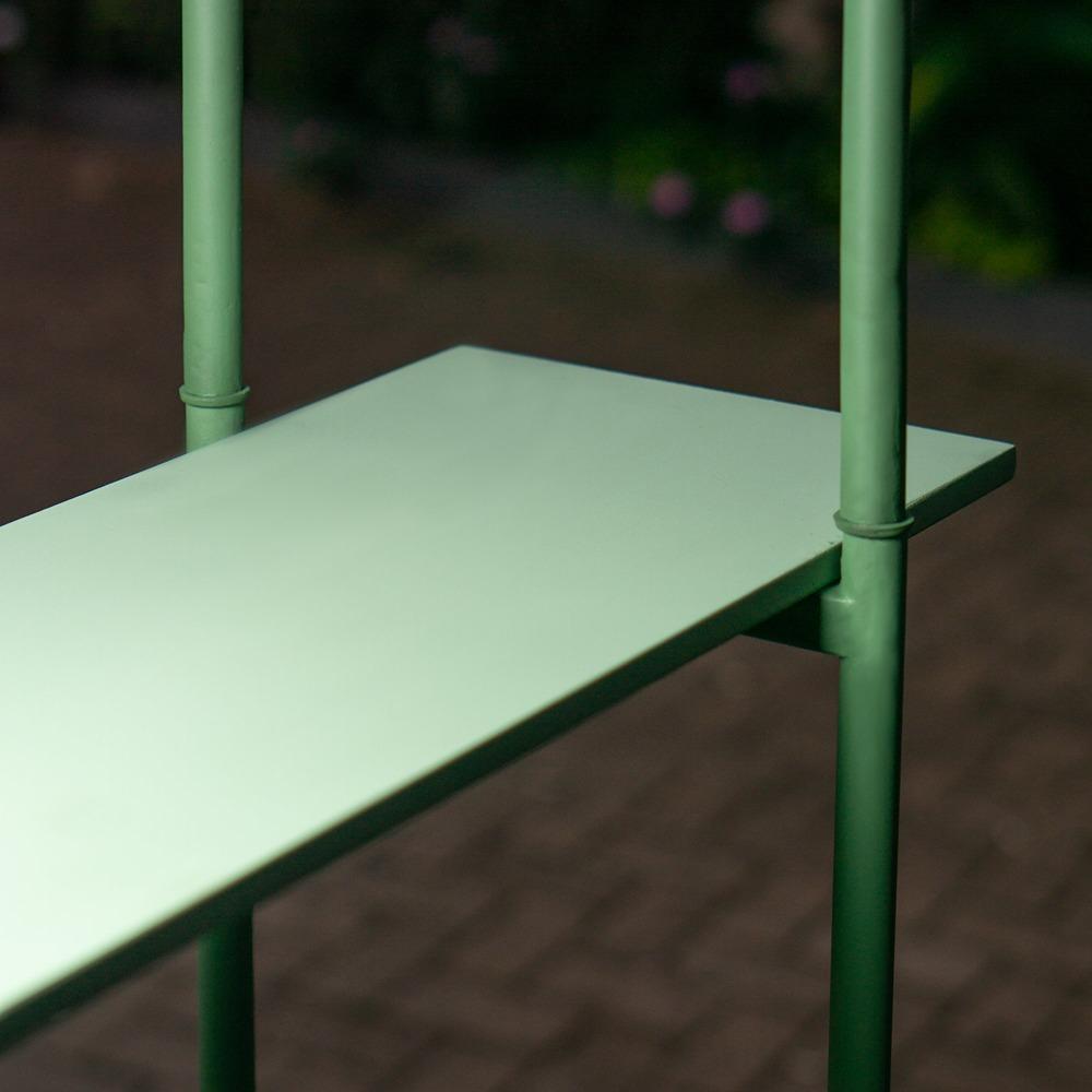 The edge of a sage board where it meets the steel post that carries it.